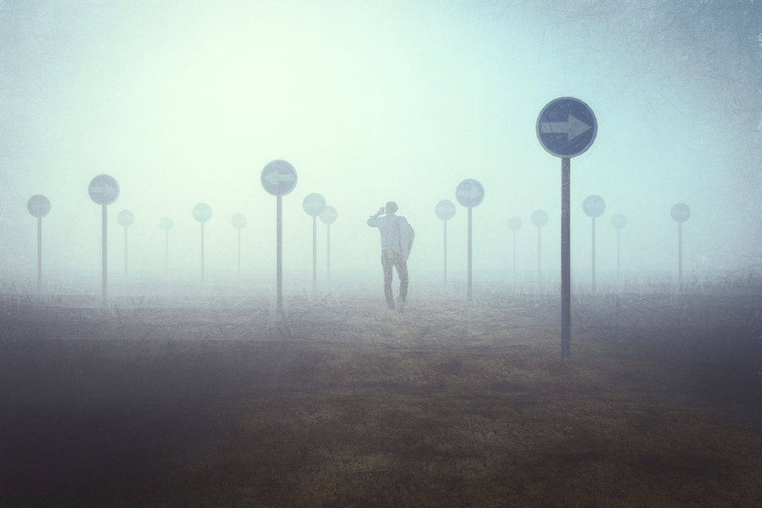 Lost Businessman in Foggy Field with Mixed Signs